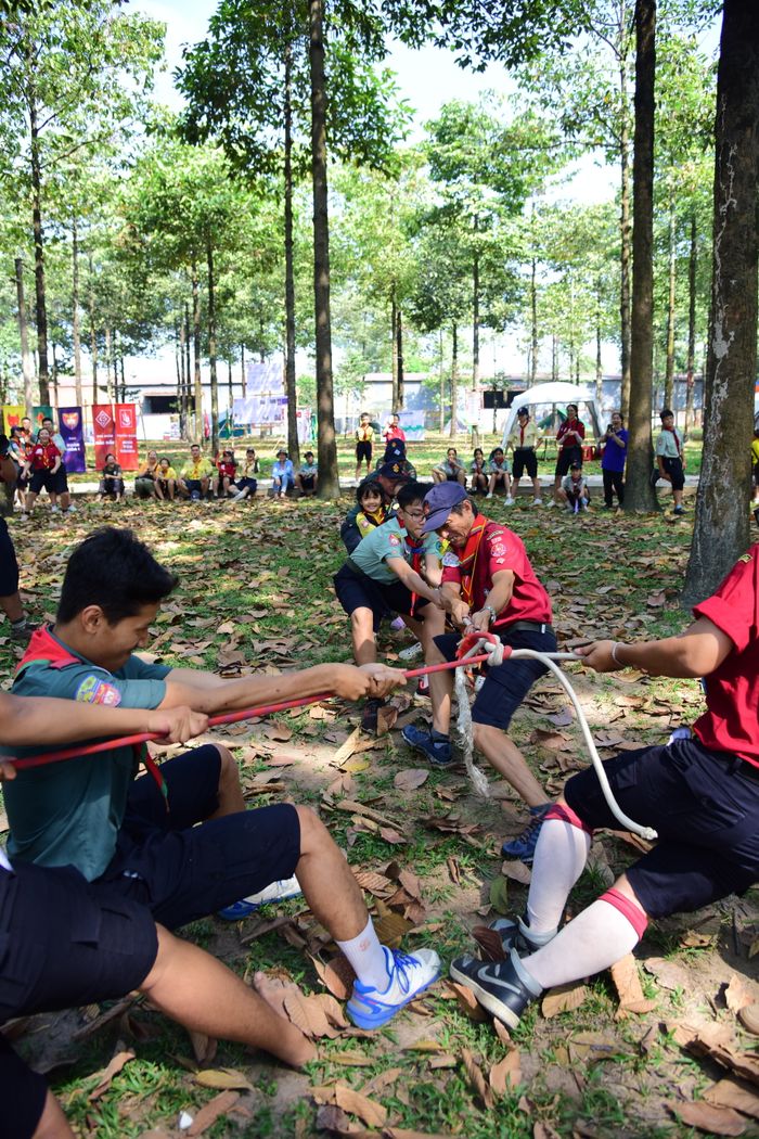 Youth participating in a lively tug-of-war game outdoors, showcasing teamwork and energy.